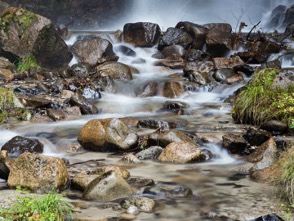 Peaceful flowing stream over rocks representing gentle aquamation pet aftercare services in Columbia